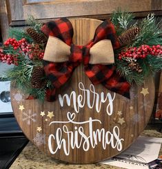 a wooden sign that says merry christmas on it