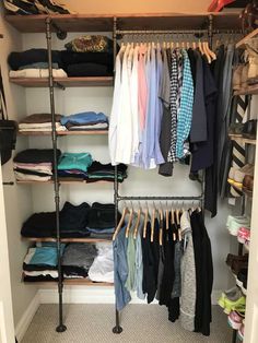 an organized closet with clothes and shoes on the shelves, along with hanging rails