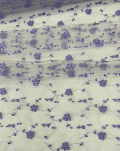 purple flowers on white sheer fabric