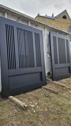 two black doors are open in front of a house