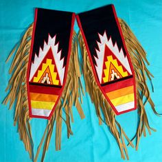 two native american flags with fringes on blue background