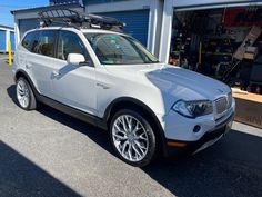 a white car parked in front of a garage