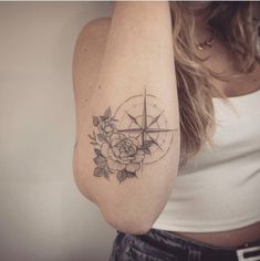 a woman with a compass tattoo on her arm