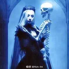 a skeleton and a woman dressed up in gothic clothing are standing next to each other