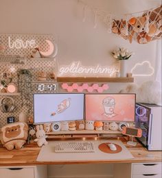 two computer monitors sitting on top of a wooden desk