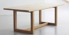 a wooden table sitting on top of a white floor