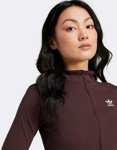 Tops by adidas Originals Your cart called, it wants this High neck Long sleeves Zip fastening Logo embroidery Slim fit Fitted Adidas Logo Top In Athleisure Style, Fitted Adidas Athleisure Top With Logo, Fitted Adidas Athleisure Top, Fitted Adidas Sportswear Tops, Fitted Sportswear Tops With Adidas Logo, Sporty Stretch Brown Tops, Sporty Brown Stretch Top, Spring Track Jacket With Three Stripes Branding, Sporty Brown Tops For Fall