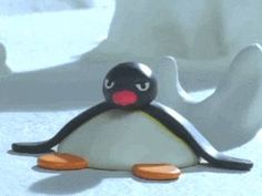 a small penguin is sitting on the ground