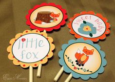 four little fox cupcake toppers with stickers on them sitting on a table