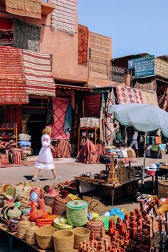 an outdoor market with baskets and other items