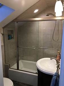 a bathroom with a sink, toilet and shower stall in it's corner area