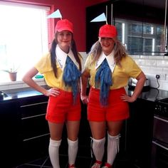 two women in red shorts and yellow shirts are posing for the camera with their hands on their hipss