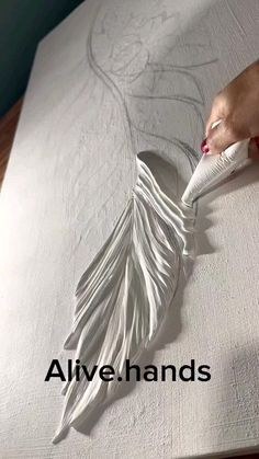 someone is using a white brush to paint a piece of fabric on a bed sheet