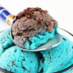 a scoop of ice cream in a bowl with blue and brown swirled icing on it