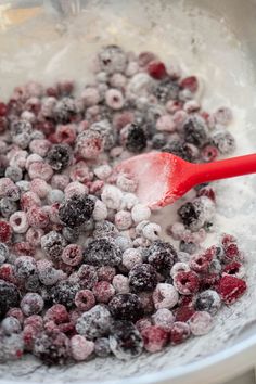 berries and sugar mixed together in a bowl