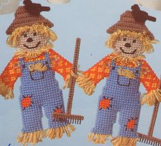 two crocheted scarecrows with hats and holding brooms on blue background