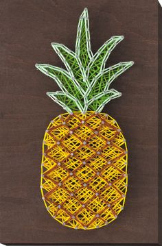 a string art pineapple on a brown background