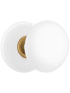 a white door knob with a brass finish