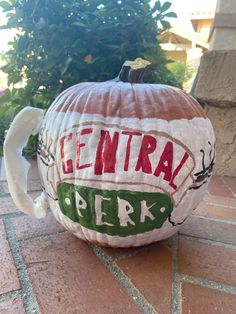 a decorated pumpkin with the words central perk painted on it's front and side