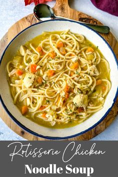 chicken noodle soup in a white bowl on a wooden board