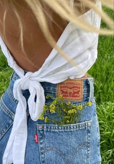 the back of a woman's jean skirt with flowers on it