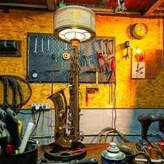 a lamp that is sitting on top of a table next to some other tools and equipment