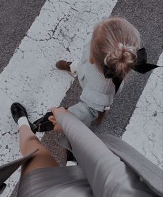 two people sitting on the ground with their legs crossed and one person wearing black shoes