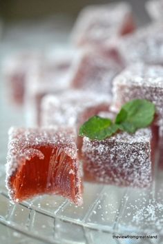 two pieces of cake sitting on top of a glass plate covered in powdered sugar