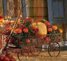 a wagon filled with lots of pumpkins and flowers