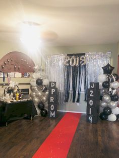 balloons and streamers decorate the entrance to a new year's eve themed party