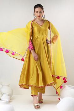 Buy Yellow Anarkali And Pant Cotton Silk Embroidered Gota Lace V Neck Set For Women by POMCHA JAIPUR Online at Aza Fashions. Yellow Suits Women Indian, Silk Suit Designs Indian Latest, Heavy Kurti Designs Latest, Yellow Suit Design, Churidar Ideas, Anarkali Suits Designer Latest, Lace Anarkali, Latest Indian Outfits, Suits For Women Indian