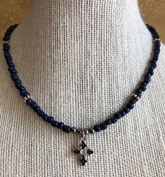 This is  the Navy Blue Choker with a Cross -The beads are  Navy Glass Rondelle Beads. -4mm is the rondelle bead size - Delicate Silver Colored  Metal Cross Pendant. -Easy to use Lobster Clasp. - Made on Satin Silver Beading Wire. - Handmade   Need a different size? Just send me a message and I'll try to accommodate you.  Thanks for looking. Blue Choker, Dainty Choker, Bead Choker, Boho Choker, Metal Cross, Fairy Wings, Beading Wire, Bead Bracelets, Necklace Choker