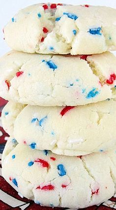 white cookies with red, white and blue sprinkles stacked on top of each other