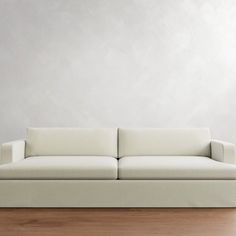 a white couch sitting on top of a wooden floor