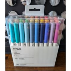 the cricut pens are lined up in a box