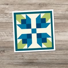 a blue and green quilt on a wooden surface