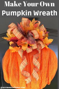 an orange pumpkin decorated with fall leaves and burlucks sits on a black chair