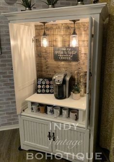 a small coffee shop with lights on the wall and some plants in pots behind it