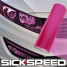 a pink sticker on the front of a white car that says stickspeed