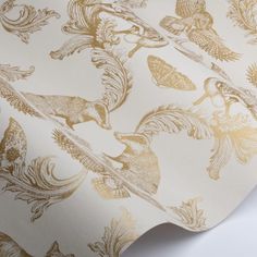 an image of a wallpaper with gold and white designs on it's surface