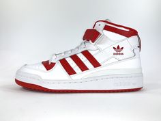 a pair of white and red sneakers on a white background with the words adidas