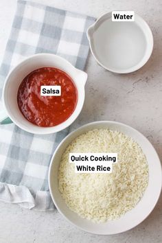 two bowls filled with rice and sauce on top of a table