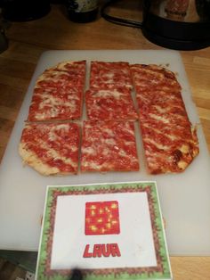 the pizza has been cut into squares and is ready to be put in the oven