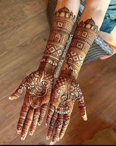 two hands with henna designs on them