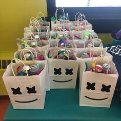 bags with faces drawn on them sitting on a table