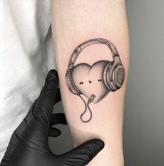 a tattoo with headphones and a heart