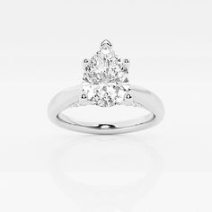 a pear shaped diamond engagement ring on a white background with reflection in the middle,