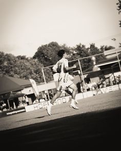 a man running across a field with a frisbee in his hand