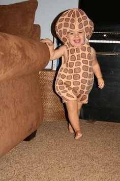 the baby is wearing a giraffe costume