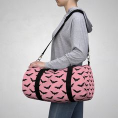 We just love this gorgeous duffel that comes in two sizes and ships from the USA! Lightweight and durable, this beautiful kawaii goth themed bag is a great way to express yourself!  Perfect for the gym, day-trip, or any other mobile storage need!  Easy to carry with you in your hands or around your shoulders, these duffel bags are ready to go anywhere! .: Made of soft Nylon .: Small and large sizes available: Small bag is 19" X 9.5" X 9.5" Harajuku Style Pink Bag For Cosplay, Novelty Black Bag For Gift, Cute Black Bags For Halloween, Harajuku Style Black Halloween Bags, Black Harajuku Style Halloween Bags, Harajuku Black Bags For Halloween, Black Novelty Bag For Everyday Use, Gothic Travel Bag For Halloween, Cute Bags For Everyday Use And Halloween